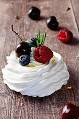 Berry Pavlova Cake dessert on the wooden background

