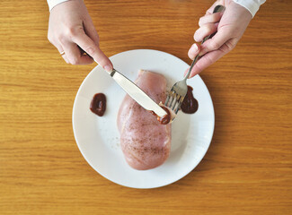 raw meat for lunch. chicken breast in a plate