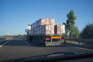 Driving behind building materials truck