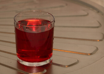 A cup of red compote in the kitchen. Health benefits