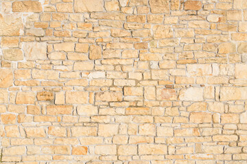 old sandstone wall stacked and placed with cement. stone background. copy for space and text.