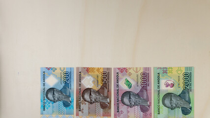 Overhead shot of Angolan Kwanzas banknotes new serie launched at the end of 2020