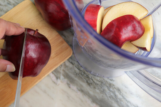 Making Juice With Apple Fruit, Blender Top View. Healthy Eating.