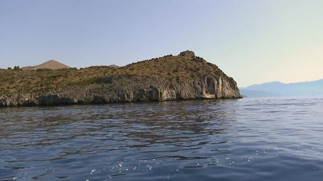 A Promontory with the remains of an ancient watchtower over a cobalt blue sea, Salerno, Italy.