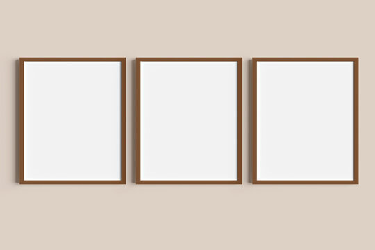 Set of three brown portrait picture frame mockups on nude wall
