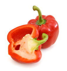 fresh red bell pepper (capsicum) and a cut one on a white background