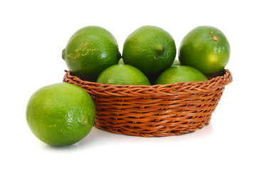 Fresh lime green in basket on a white background.