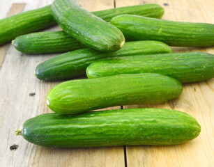 fresh cucumbers isolated on wooden board
