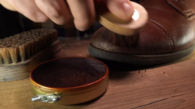 Caucasian Male Puts Wax on Leather Shoe with Cleaning Set of Brush Cloth and Polish Wax Close Up

