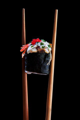 sushi roll with chopsticks