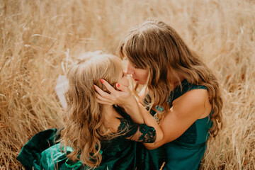 Mom hugs and laughs with her daughter in nature