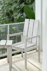 Fototapeta na wymiar A weathered wooden chair on the balcony.