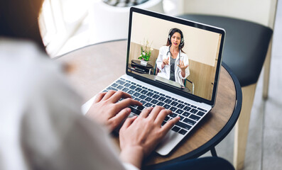 Woman talk speak using laptop computer and video conference online with doctor and stethoscope service help support team discussing and consulting talk video chat call checkup information at home