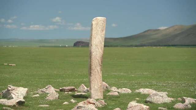 Inscription of obelisk menhir from old ancient times.Deer stone is megalith carved with symbols.Deerstone cemeteries orthostat stele steppe history historical antique petroglyph monuments memorial 4K