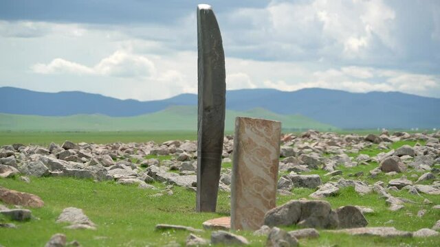 Inscription of obelisk menhir from old ancient times.Deer stone is megalith carved with symbols.Deerstone cemeteries orthostat stele steppe history historical antique petroglyph monuments memorial 4K
