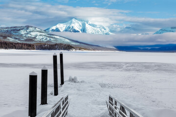 Winter landscape of frozen Lake McDonald dock in Glacier National Park, Montana