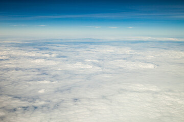 Clouds and sky as seen through window of an aircraft