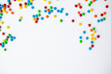 cheerful flat lay white backdrop scene surrounded by rainbow candies