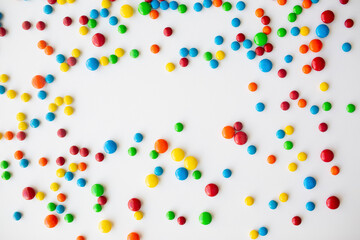 cheerful flat lay white backdrop scene surrounded by rainbow candies