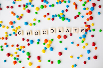 cheerful flat lay white backdrop scene surrounded by rainbow candies