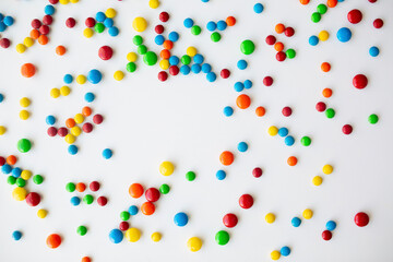 cheerful flat lay white backdrop scene surrounded by rainbow candies