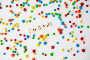 cheerful flat lay white backdrop scene surrounded by rainbow candies