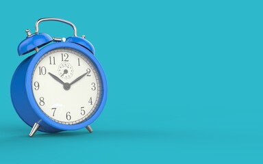 Blue vintage alarm clock on light blue color background