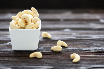 Full Raw Cashew Nuts in white ceramic bowl