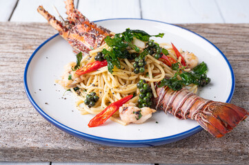 Spaghetti with spicy lobsters in white plate