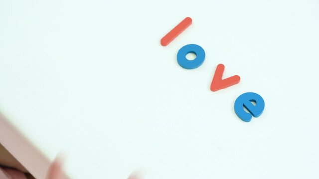 Happy Family concept ,Mother and lovely daughter  Spelling Scramble  word of LOVE.