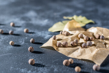 Allspice (jamaica pepper) sprinkled on baking paper.