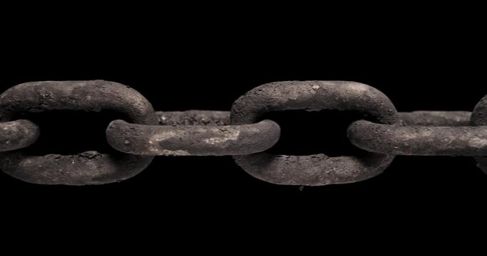 Slow panning across an old rusty chain showing each link pulled taut. Concept of strength, security, or strong connection.