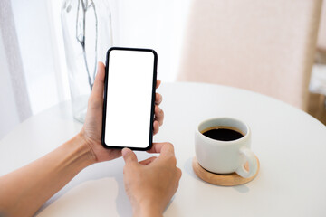 cell phone blank white screen mockup.woman hand holding texting using mobile on desk at office.background empty space for advertise.work people contact marketing business,technology