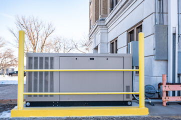 Outdoor natural gas emergency generator with protective bollards - obrazy, fototapety, plakaty