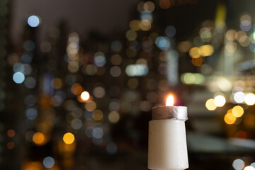 candles on table, twinkling blurred city night lights in background, romantic concept for lovers...