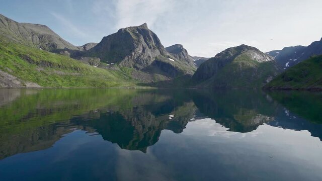 Vivid Images Of Rocky Hills Reflected On Transparent Lake In Norway During Daytime. - Static Shot