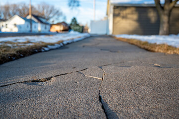 Frost heave crack in residential concrete sidewalk