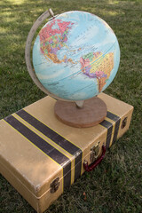 Globe on a Suitcase in the Grass