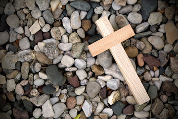 Wooden Cross on a Bed of River Rocks