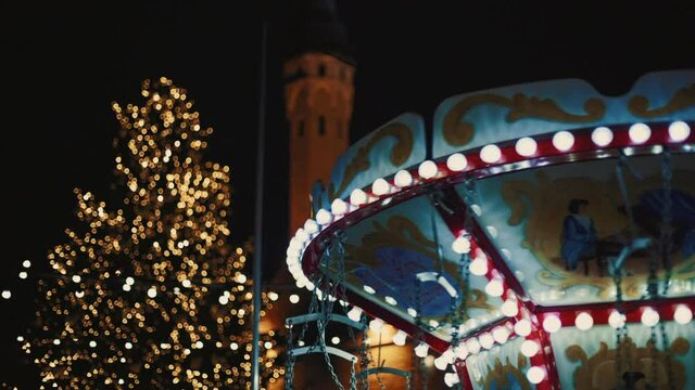 Colorful carousel spinning around in the Tallinn Christmas market. Tilt up and down