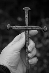 Metal Nail Cross held in a Hand