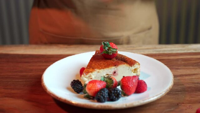 Chef throw smash berries on cheesecake
