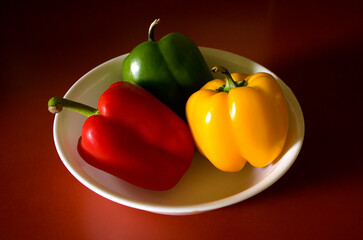 Red, Green, Yellow Peppers in a Bowl