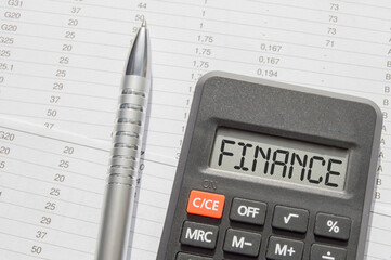 The concept of business and Finance. On the reporting is a pen and a calculator, on which the text...