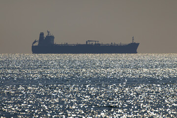 Silhouette container ship entering Mersin Port