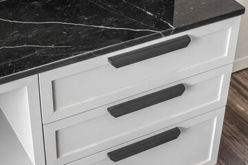 White drawers and cabinets contrast with black, perfect modern style, the top of the drawer is made of marble.