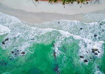 Above view from drone of wave sand sea and beach.