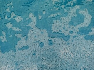 The little bubbles made an irregular pattern over the pool as everyone left them