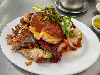 Plate of delicious Chinese Hainan roasted chicken and pork