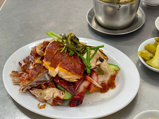 Plate of delicious Chinese Hainan roasted chicken and pork
